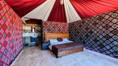 a bedroom with a bed in a tent at WhyDesert Camp & Tours in Wadi Rum