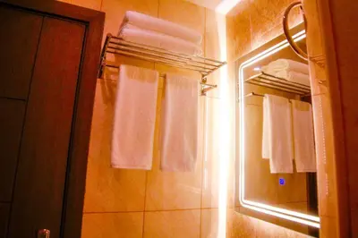 a bathroom with white towels and a mirror at ِAfnan hotel in Aqaba