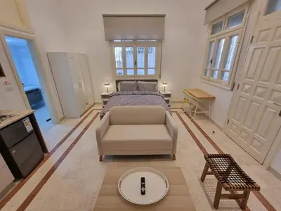 a bedroom with a bed and a couch and a table at Downtown Living Boutique Apartments in Amman