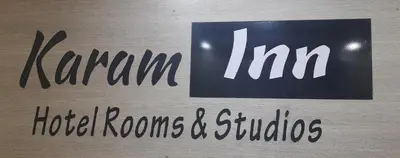 a sign that says karma inn hotel rooms and suites at Karam Inn in Aqaba