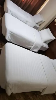 a group of white pillows sitting on a floor at Karam Inn in Aqaba