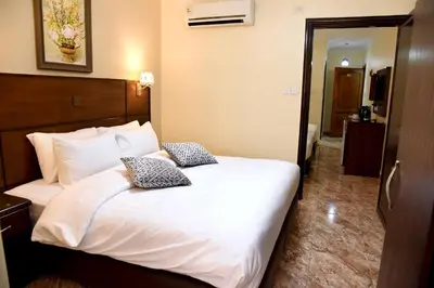 a bed in a hotel room with two pillows on it at Karam Inn in Aqaba