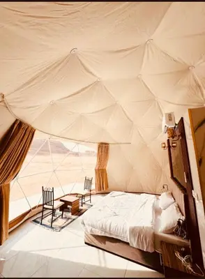 a bedroom with a bed in a tent at MAGIC RUM lUXURY HUSSEN in Wadi Rum