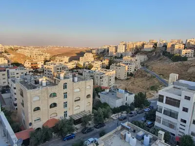 an aerial view of a city with tall buildings at Suad Apartment in Amman
