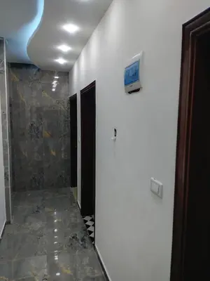 a bathroom with a television on a white wall at شقة فاخرة مع مطل luxerious with nice view in Amman