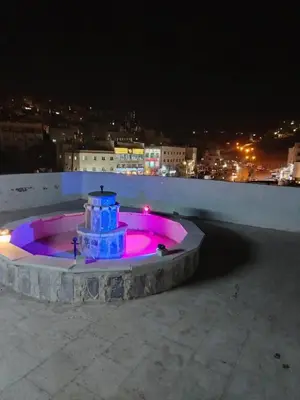 a lighted fountain on the roof of a building at night at شقة فاخرة مع مطل luxerious with nice view in Amman