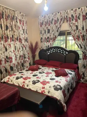 a bedroom with a bed with a quilt on it at 3 bedroom apartment in Ţāb Kirā‘