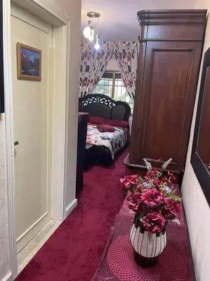 a hallway with a vase of flowers in a room at 3 bedroom apartment in Ţāb Kirā‘
