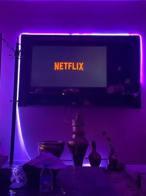 a purple room with a sign that reads netflix at 3 bedroom apartment in Ţāb Kirā‘