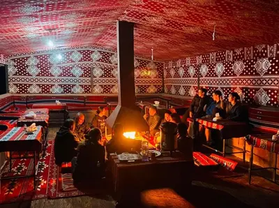 a group of people sitting at tables in a restaurant at Wadirum winter in Wadi Rum