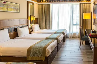 a hotel room with two beds and a window at شقق المومني in Amman