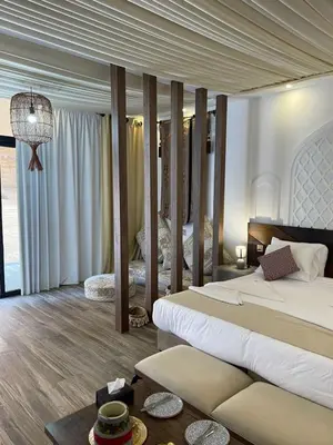 a large bedroom with two beds and a table at Imagination Luxury Camp in Disah
