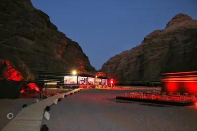 a building with red lights in front of a mountain at Imagination Luxury Camp in Disah