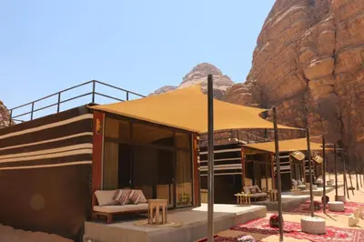 a building with a tent in the desert at Imagination Luxury Camp in Disah