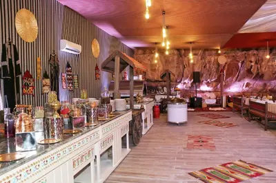 a restaurant with a counter in a room with animals on the wall at Imagination Luxury Camp in Disah