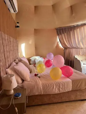 a room with a bed with balloons on it at Golden Gate Luxury Camp in Wadi Rum