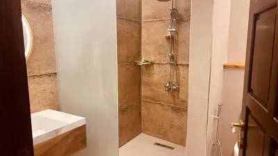 a bathroom with a shower with a sink at Saraya locanda in Al Salt