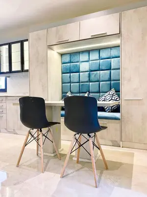 two chairs sitting next to a table in a kitchen at Odeh Residence in Aqaba
