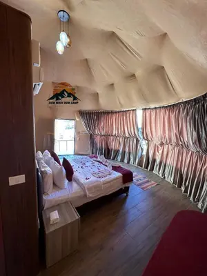 a bedroom with a bed in a tent at Gem wadi rum camp in Wadi Rum