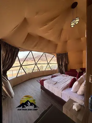 a bedroom with a large bed in a tent at Gem wadi rum camp in Wadi Rum