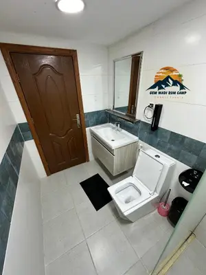 a bathroom with a toilet and a sink at Gem wadi rum camp in Wadi Rum