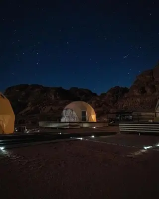 a large dome tent in the desert at night at Rum Plaza Luxury Camp in Wadi Rum