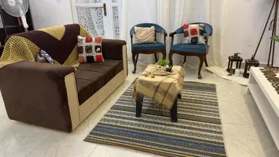a living room with a couch and chairs and a table at Little Green Farm in Wadi Musa
