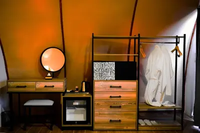 a bedroom with a desk and a mirror and a dresser at Shell Luxury Camp in Wadi Rum