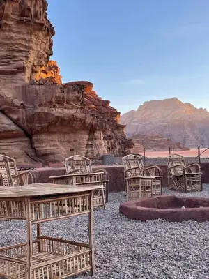 a group of chairs and a table in the desert at Mira Bedouin Camp in Wadi Rum