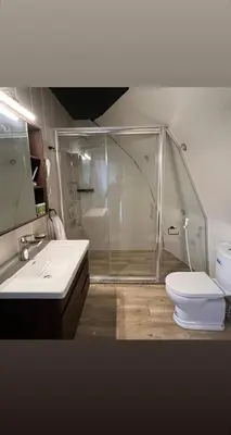 a bathroom with a shower and a toilet and a sink at Madar Camp, Wadi Rum in Wadi Rum