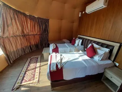 a bedroom with two beds in a room at Madar Camp, Wadi Rum in Wadi Rum