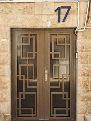 a pair of doors with the number seventy on them at CMK Housing in Madaba