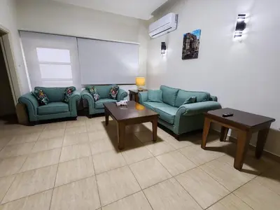 a living room with two couches and a table at CMK Housing in Madaba