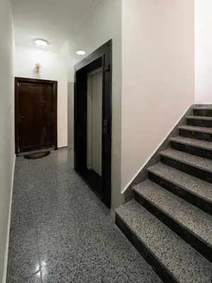 a hallway with stairs leading to a door and a door at ENG-Murjan Apartment in Aqaba