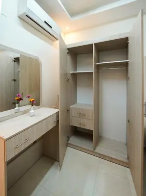 a walk in closet with a sink and a mirror at ENG-Murjan Apartment in Aqaba