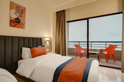a bedroom with a bed and a table and chairs at The Loft hotel By FHM in Aqaba