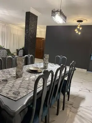 a dining room with a table and chairs and a table and chairsktop at Luxury 4-bedrooms apartment in Aqaba