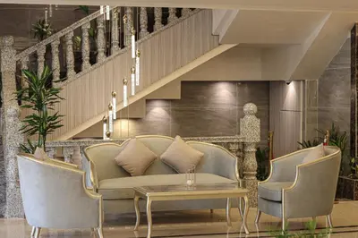 a living room with a couch and chairs and a table at Rival Hotel Amman in Amman