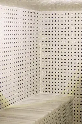 a bedroom with a white wall with polka dots at Rival Hotel Amman in Amman