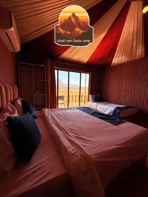 a bedroom with a large bed in a room at Wadi Rum Santa Camp in Wadi Rum