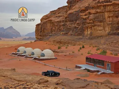 a car parked in front of a building in the desert at wadi rum,Linda Camp in Wadi Rum