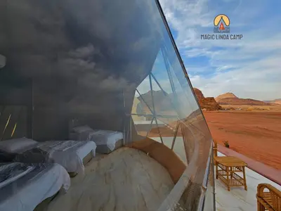 a room with two beds and a view of the desert at wadi rum,Linda Camp in Wadi Rum