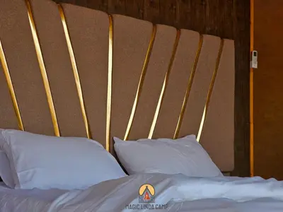 a bed with white pillows in a room at wadi rum,Linda Camp in Wadi Rum