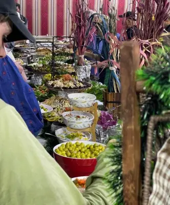 a buffet line with plates of food on display at Joker camp Wadi Rum in Disah