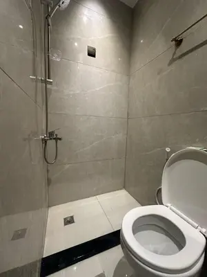 a bathroom with a toilet and a shower at Aladnan hotel in Aqaba