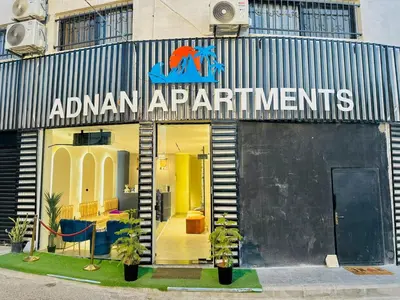 a store front with a sign that reads amazon apartmentments at Aladnan hotel in Aqaba