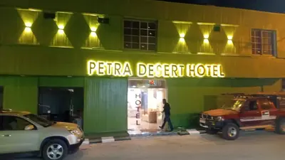 two cars parked outside of a peraja desert hotel at Petra Desert Hotel in Wadi Musa