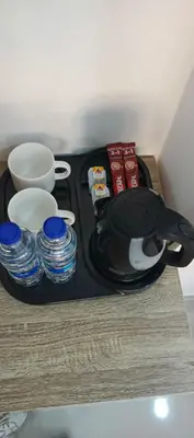 a black tray with plates and cups on a table at Petra Desert Hotel in Wadi Musa