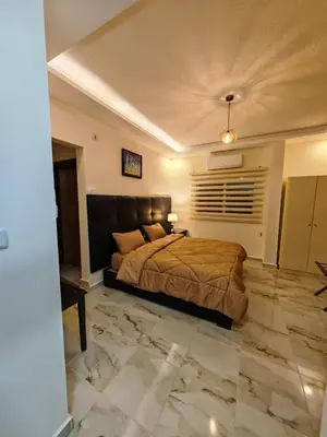 a bedroom with a large bed and a large stone floor at iHome Petra in Wadi Musa
