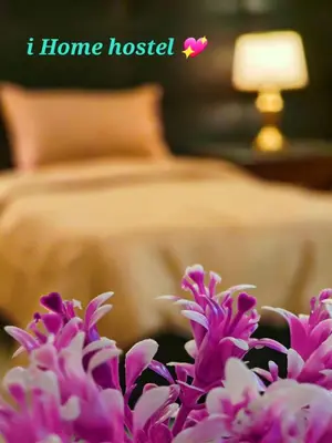 a bed with pink flowers in front of a bed at iHome Petra in Wadi Musa